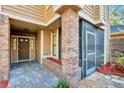 Welcoming front porch featuring brick columns and a screened-in entry at 7217 Dr Phillips Blvd, Orlando, FL 32819