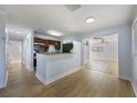 Bright, open-concept living space with modern flooring, connecting kitchen and living area at 10526 Fernando St, Orlando, FL 32825