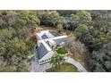 Aerial view of estate showing lush landscaping, winding drive, and elegant architecture at 1109 Brownshire Ct, Longwood, FL 32779