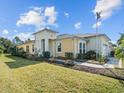 Charming home featuring lush lawn, beautiful landscaping, and an American flag at 1132 Fins Up Ct, Daytona Beach, FL 32124