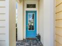 Inviting home exterior with a striking blue front door and a 'Beach Happy' welcome mat at 1132 Fins Up Ct, Daytona Beach, FL 32124