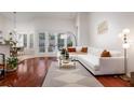 Bright living room featuring a white sofa, hardwood floors, and sliding glass doors to the outdoors at 1165 Cardinal Creek Pl, Oviedo, FL 32765