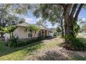 Well-maintained single-story home with manicured landscaping, green grass and a paved driveway at 1224 Shorecrest Cir, Clermont, FL 34711