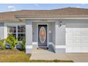 Close up shot of a home's front entrance, complete with a glass oval door at 13258 Sw 29Th Cir, Ocala, FL 34473