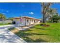 Charming home with a red tile roof, American flag, and attached garage at 14 E Cypress St, Davenport, FL 33837