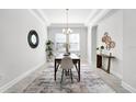 Elegant dining room with modern chandelier, stylish decor, and plenty of natural light at 14101 Creekbed Cir, Winter Garden, FL 34787