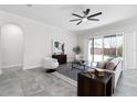 Bright living room with tile floors, stylish furniture, and sliding glass doors to the patio at 14101 Creekbed Cir, Winter Garden, FL 34787