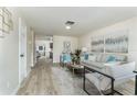 Bright living room with modern decor, neutral tones, and wood-look flooring at 1433 Ne Old Mill Dr, Deltona, FL 32725