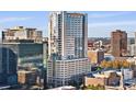 Modern high-rise building with glass windows in a busy urban setting at 155 S Court Ave # 1705, Orlando, FL 32801