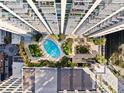 Overhead aerial view of a pristine outdoor pool surrounded by lush landscaping at 155 S Court Ave # 1705, Orlando, FL 32801