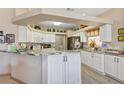 Bright kitchen with white cabinets, granite countertops and stainless steel appliances at 15705 Sw 16Th Ter, Ocala, FL 34473