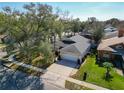 This aerial view showcases a well-maintained home, lush yard, and a peaceful neighborhood setting at 4371 Weeping Willow Cir, Casselberry, FL 32707