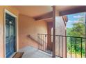 Hallway view features a blue front door, view of outside greenery and stairway with handrail at 5120 Conroy Rd # 32, Orlando, FL 32811