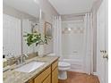 Bright bathroom with granite countertops, a shower-tub combo, and neutral decor at 6542 Swissco Dr # 813, Orlando, FL 32822