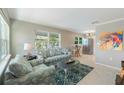 Open living room flows into kitchen featuring tile floors, stainless steel appliances, and modern lighting at 705 Liberty St, Eustis, FL 32726