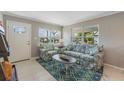 Cozy living room with light gray walls, large windows, and stylish furnishings at 705 Liberty St, Eustis, FL 32726