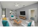 Bright living room features tile floors and neutral paint at 7123 Yacht Basin Ave # 328, Orlando, FL 32835