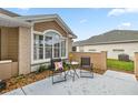 This patio has neutral tones, an attractive window, and comfortable outdoor seating at 7296 Sw 115Th Pl, Ocala, FL 34476