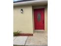 A close-up of a modern front door with glass insert and digital entry at 7727 Harbor Lake Dr, Orlando, FL 32822