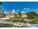 Beautifully landscaped home with a three-car garage, manicured lawn, and a decorative palm tree at 824 Preserve Ter, Lake Mary, FL 32746