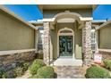 Elegant home entrance with decorative stone accents and a beautiful wrought iron double door at 824 Preserve Ter, Lake Mary, FL 32746