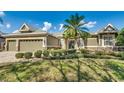 Well-maintained home with a green lawn, decorative shrubbery, and a central palm tree at 824 Preserve Ter, Lake Mary, FL 32746