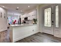 A modern kitchen with white cabinets and white granite countertops at 8443 Via Bella Notte, Orlando, FL 32836