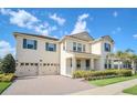 Charming two-story home featuring blue shutters, a three-car garage, and manicured landscaping at 9014 Sonoma Coast Dr, Winter Garden, FL 34787