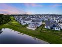 Aerial view of homes in a well-planned neighborhood, showcasing beautiful landscaping and lake views at 9752 Petition Way, Orlando, FL 32832