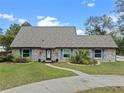 Charming brick home featuring well-manicured landscaping and walkway leading to the front entrance at 1134 Glenwood Rd, Deland, FL 32720