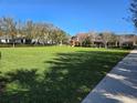 Expansive community park with lush green lawn, mature trees, and nearby homes at 14214 Shocklach Dr, Winter Garden, FL 34787