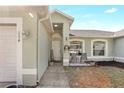 Inviting front entry with a welcome sign, chairs, and a charming front door at 154 Desiree Aurora St, Winter Garden, FL 34787