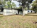 View of home's front yard, house number, and side detached structure at 2426 Barbarossa Ave, Deltona, FL 32738
