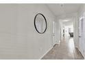 Neutral hallway featuring a large decorative mirror and easy access to other rooms in the home at 2890 Avian Loop, Kissimmee, FL 34741