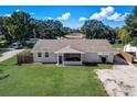 An aerial perspective reveals a well-maintained home and lawn, complete with a screened-in front porch at 290 Orange Ave, St Cloud, FL 34769
