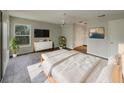 Bright main bedroom featuring sleek furnishings, a flatscreen TV, a ceiling fan, and wood-look floors at 38 Emerald Ct, Ocala, FL 34472