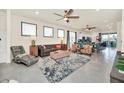 Open-concept living room featuring stylish seating, neutral decor and a view of the kitchen at 3811 Lana Ave, Davenport, FL 33897