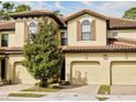 Charming townhome with a terra cotta tile roof and a tree in the front yard at 8141 Roseville Blvd, Davenport, FL 33896