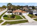 Inviting home with lush lawn, mature palm, and a white fenced yard at 600 Park Valley Cir, Minneola, FL 34715