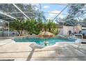 Inviting enclosed pool featuring a built-in bar-style table with sun umbrella at 10400 Windermere Chase Blvd, Gotha, FL 34734