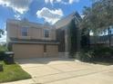 Traditional-style home with a manicured front yard and an attached two-car garage at 10446 Stone Glen Dr, Orlando, FL 32825