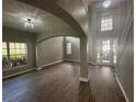 Open-concept living room with high ceilings, wood flooring, and plenty of natural light at 10446 Stone Glen Dr, Orlando, FL 32825
