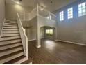 Spacious living room featuring a staircase, soaring ceilings, and ample natural light at 10446 Stone Glen Dr, Orlando, FL 32825