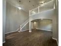 Bright living room featuring a staircase, soaring ceilings, and modern lighting at 10446 Stone Glen Dr, Orlando, FL 32825