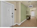 Hallway leading into unit 302 with a neutral color palette at 1338 Seven Eagles Ct # 302, Reunion, FL 34747