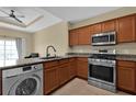 Kitchen area features stainless steel appliances and breakfast bar at 1338 Seven Eagles Ct # 302, Reunion, FL 34747