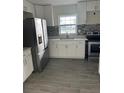 Well-equipped kitchen featuring stainless steel appliances and sleek white cabinetry at 1926 Kingsland Ave, Orlando, FL 32808