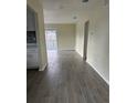 Spacious living area with sliding glass doors, gray wood-look tile flooring, and neutral walls at 1926 Kingsland Ave, Orlando, FL 32808