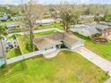 An aerial view of a well-maintained home with fenced yard, green lawn, and beautiful landscaping at 2130 Pope Ave, South Daytona, FL 32119