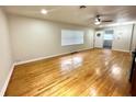 Spacious living room featuring gleaming hardwood floors and a ceiling fan at 2394 Orange Center Blvd, Orlando, FL 32805